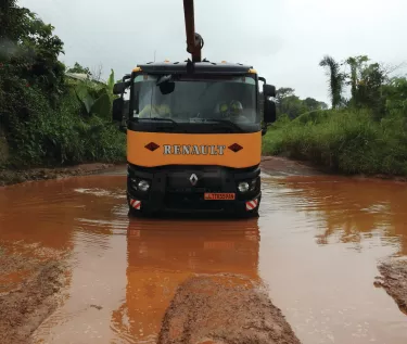 Renault Trucks K crossing a big pool of muddy water in Cameroon
